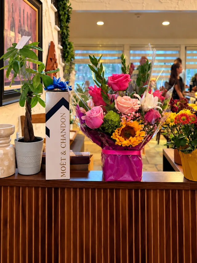 Roses and a sunflower at Olive & Oak's wooden reception desk